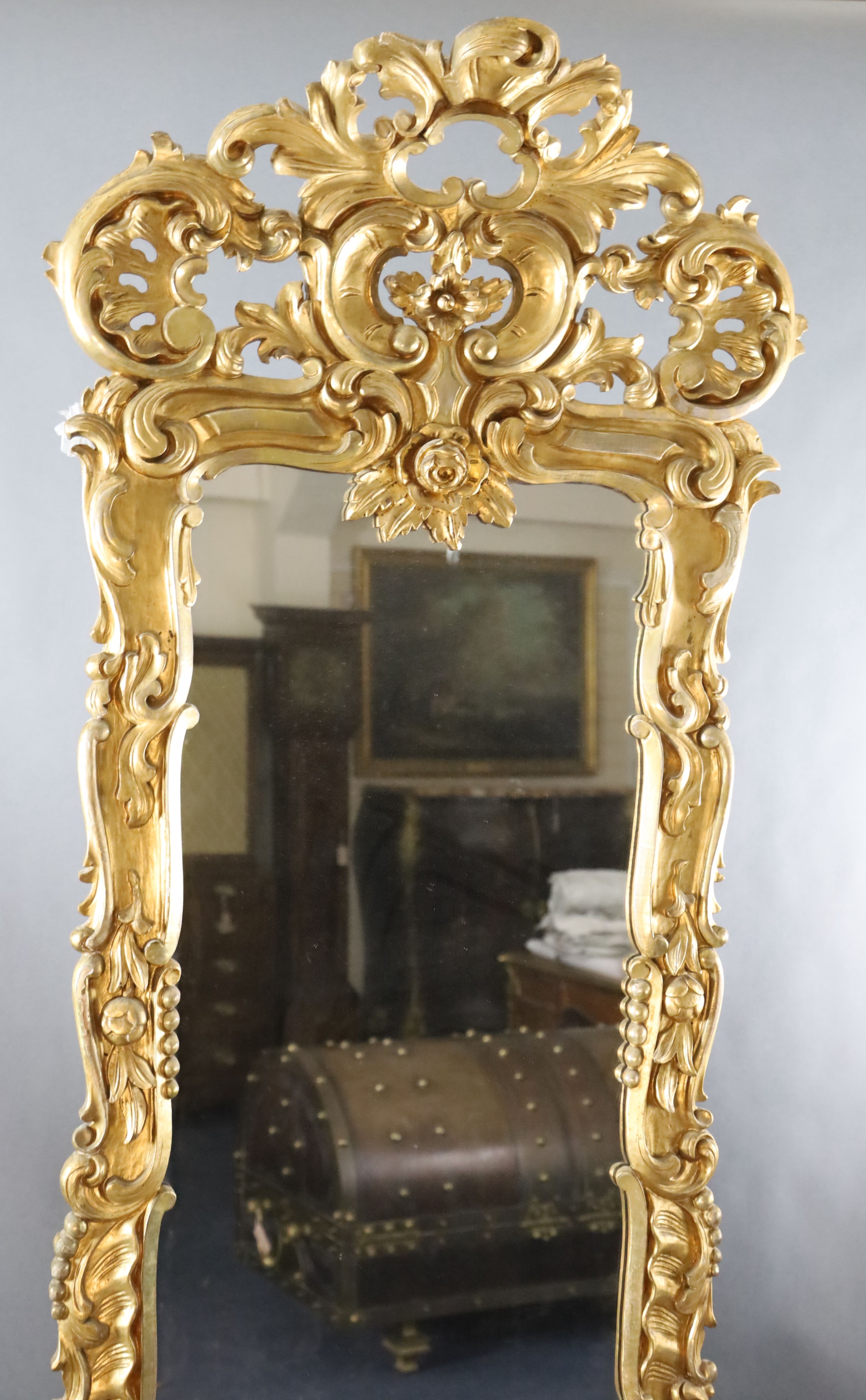 A late 19th century French carved giltwood wall mirror, W.3ft 3in. H.8ft 5in.